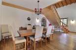 This charming dining room features a rustic wooden table and chairs, perfect for family gatherings.