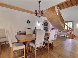 This charming dining room features a rustic wooden table and chairs, perfect for family gatherings.