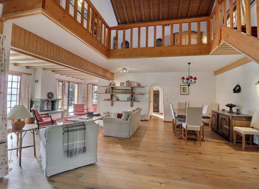 Step into luxury with this stunning property featuring a spacious living area with a cozy fireplace.