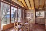 This charming dining room boasts stunning mountain views through large windows, creating a bright and inviting atmosphere.