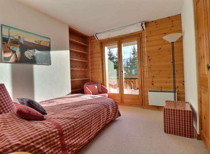 Discover a cozy bedroom retreat with stunning mountain views.