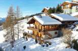 Discover a stunning chalet nestled in a picturesque snowy landscape.