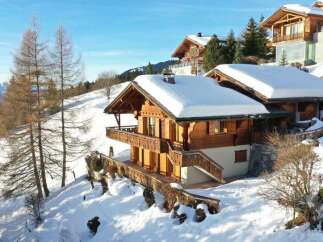 Discover a stunning chalet nestled in a picturesque snowy landscape.