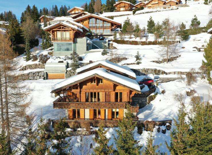 Discover the epitome of luxury living in this stunning chalet nestled amidst a picturesque snow-covered landscape.