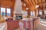 Experience the warmth of this stunning chalet, featuring a cozy fireplace and inviting seating areas.