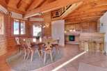 Step into this charming chalet-style dining area, featuring a warm, inviting ambiance with its wooden beams and paneling.