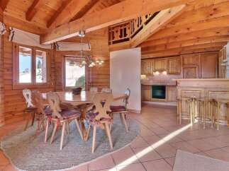 Step into this charming chalet-style dining area, featuring a warm, inviting ambiance with its wooden beams and paneling.