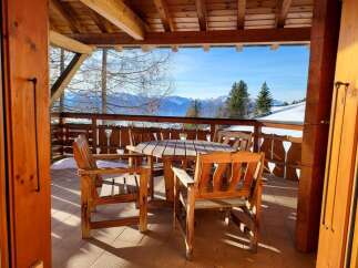 Enjoy breathtaking mountain views from this charming outdoor seating area.