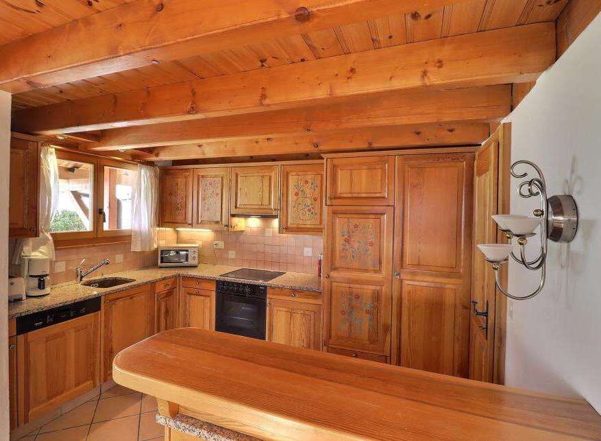This charming kitchen features warm wooden cabinetry and a cozy atmosphere.