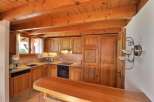 This charming kitchen features warm wooden cabinetry and a cozy atmosphere.
