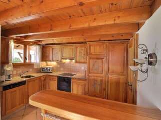 This charming kitchen features warm wooden cabinetry and a cozy atmosphere.