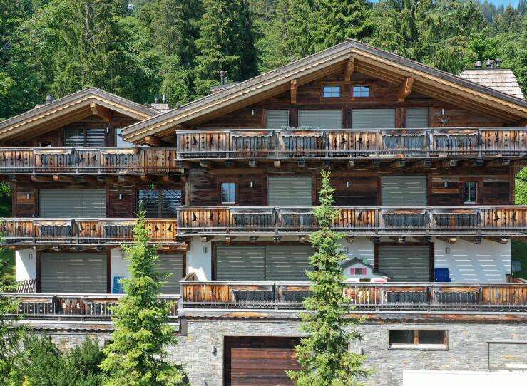 Discover the charm of this stunning chalet-style property nestled amidst lush greenery.
