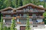 Discover the charm of this stunning chalet-style property nestled amidst lush greenery.