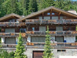 Discover the charm of this stunning chalet-style property nestled amidst lush greenery.