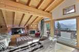 Experience luxury living in this stunning chalet, featuring a cozy fireplace and a spacious living area.