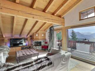 Experience luxury living in this stunning chalet, featuring a cozy fireplace and a spacious living area.