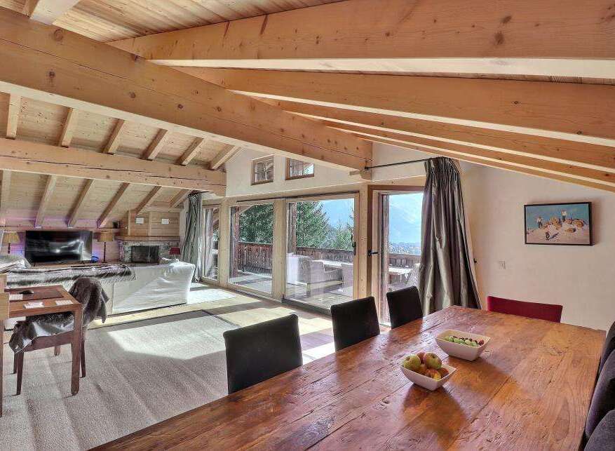 Experience luxury living in this stunning property featuring a spacious living area with a cozy fireplace and a modern TV.