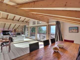 Experience luxury living in this stunning property featuring a spacious living area with a cozy fireplace and a modern TV.