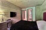 This cozy bedroom features a rustic wooden design, creating a warm and inviting atmosphere.
