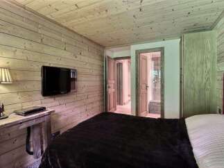 This cozy bedroom features a rustic wooden design, creating a warm and inviting atmosphere.