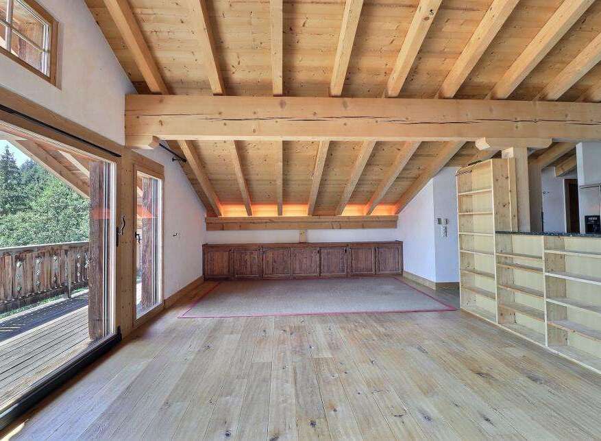 Experience the charm of this stunning property, featuring a spacious interior with exposed wooden beams and a warm, inviting atmosphere.