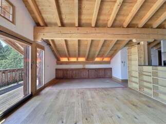 Experience the charm of this stunning property, featuring a spacious interior with exposed wooden beams and a warm, inviting atmosphere.
