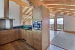 This stunning kitchen boasts a modern design with natural wood cabinetry and sleek stainless steel appliances.