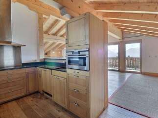 This stunning kitchen boasts a modern design with natural wood cabinetry and sleek stainless steel appliances.