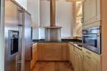 This stunning kitchen boasts modern appliances and a sleek design, perfect for culinary enthusiasts.
