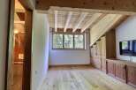 This stunning property boasts a unique architectural design with exposed wooden beams and a warm, inviting atmosphere.