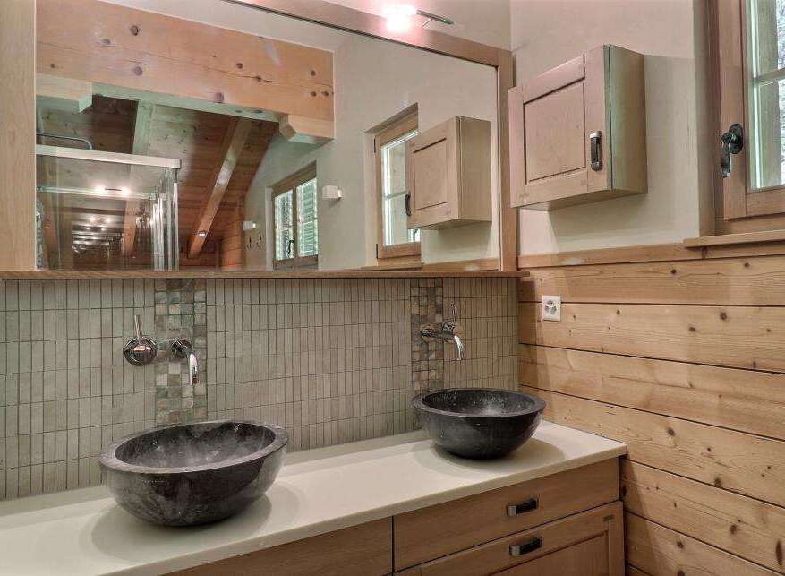 This stunning bathroom boasts a unique design with its wooden accents and modern fixtures.