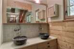 This stunning bathroom boasts a unique design with its wooden accents and modern fixtures.