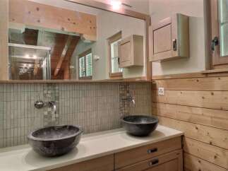 This stunning bathroom boasts a unique design with its wooden accents and modern fixtures.