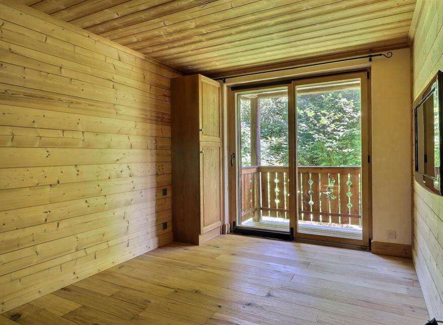 This cozy room features beautiful wooden walls and flooring, creating a warm and inviting atmosphere.
