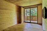This cozy room features beautiful wooden walls and flooring, creating a warm and inviting atmosphere.