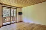 This inviting room features a beautiful wooden ceiling and flooring, creating a warm and natural ambiance.