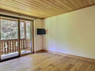 This inviting room features a beautiful wooden ceiling and flooring, creating a warm and natural ambiance.