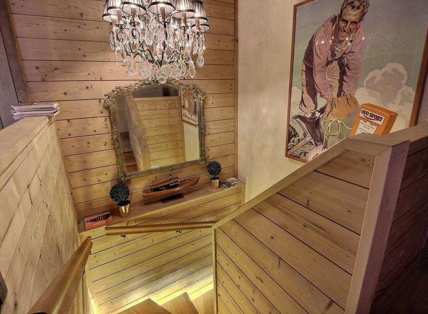 This stunning property features a beautifully crafted wooden staircase, exuding warmth and elegance.