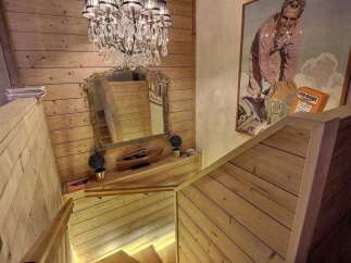 This stunning property features a beautifully crafted wooden staircase, exuding warmth and elegance.