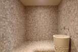 Step into luxury with this stunning bathroom featuring a unique mosaic tile design.