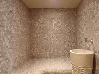 Step into luxury with this stunning bathroom featuring a unique mosaic tile design.