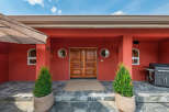 This stunning property boasts a striking red exterior, creating a bold and inviting first impression.