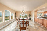 This elegant dining room features a stunning chandelier and a large oval dining table, perfect for hosting gatherings.