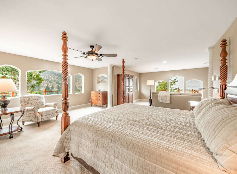 Experience luxury in this stunning bedroom featuring a four-poster bed and elegant decor.