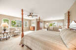 Experience luxury in this stunning bedroom featuring a four-poster bed and elegant decor.