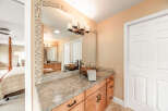 This beautiful bathroom features a stylish vanity with a unique vessel sink and a stunning mosaic mirror frame.