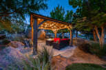 Experience luxury living in this stunning outdoor oasis! This property features a beautifully designed gazebo with string lights, perfect for evening gatherings.