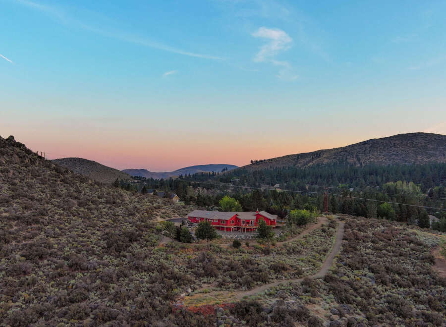 Nestled amidst the serene beauty of the mountains, this stunning red property offers a unique blend of privacy and natural splendor.