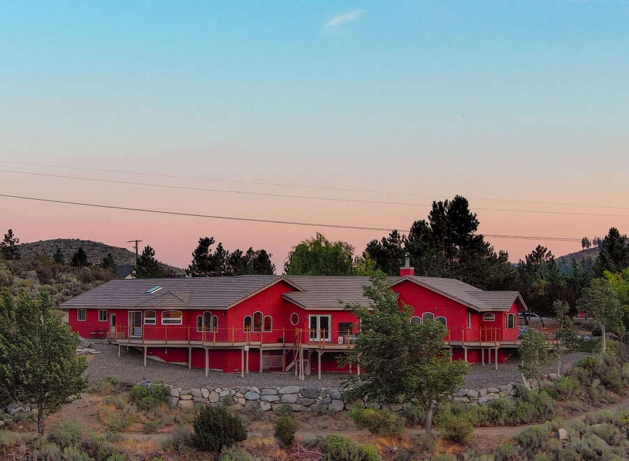 This stunning red home offers a unique blend of rustic charm and modern comfort.