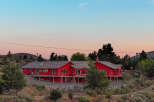 This stunning red home offers a unique blend of rustic charm and modern comfort.